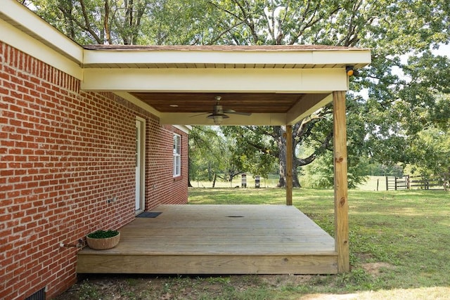 wooden terrace with a yard and ceiling fan