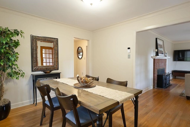 dining room with hardwood / wood-style flooring and crown molding