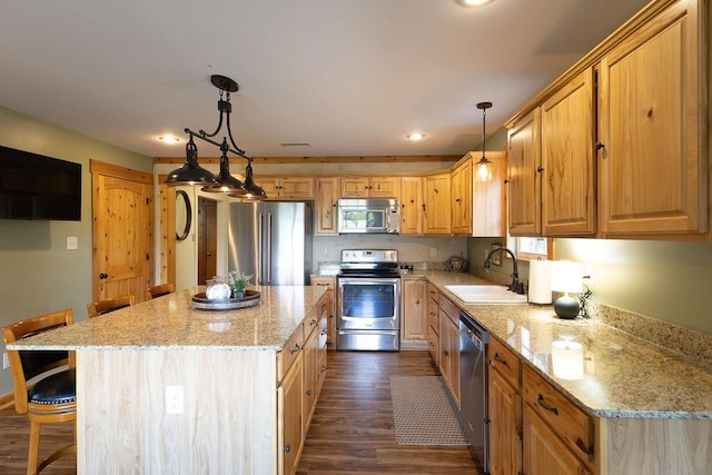 kitchen featuring a kitchen island, dark wood-type flooring, sink, appliances with stainless steel finishes, and decorative light fixtures