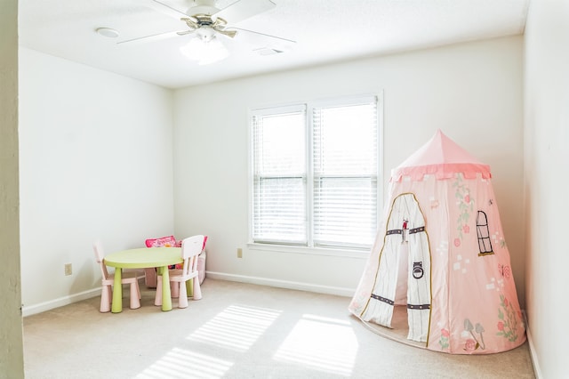 rec room featuring carpet floors and ceiling fan