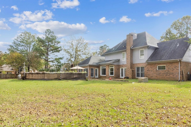 back of house with a yard