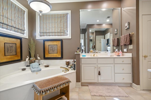 bathroom featuring tile patterned flooring, a bathtub, crown molding, and vanity