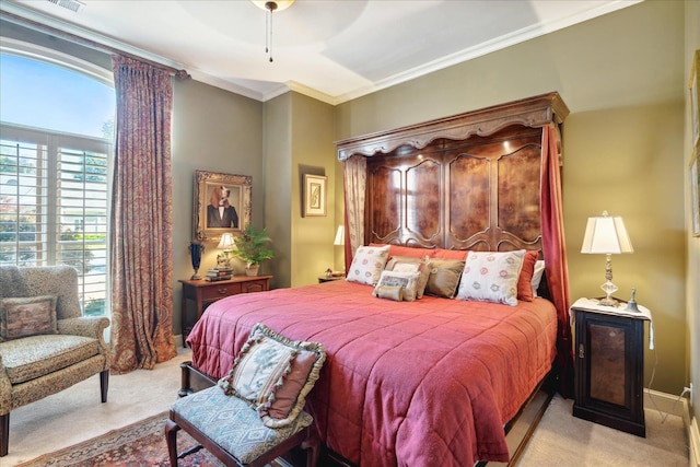 carpeted bedroom featuring ceiling fan and crown molding