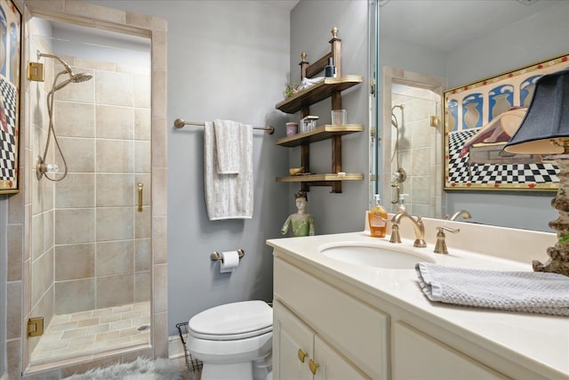 bathroom with a shower with shower door, vanity, and toilet