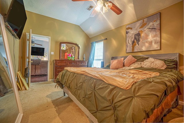 bedroom featuring light carpet, ceiling fan, vaulted ceiling, and a textured ceiling