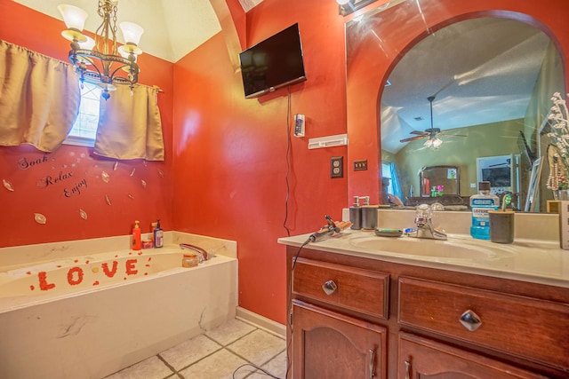 bathroom with vanity, a bathing tub, ceiling fan with notable chandelier, tile patterned floors, and vaulted ceiling