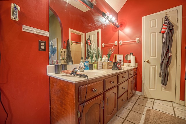 bathroom featuring vanity and lofted ceiling