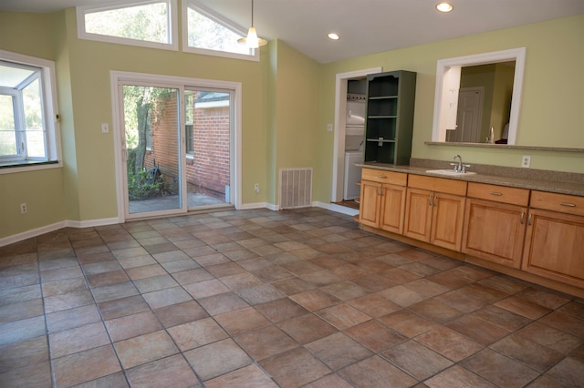 kitchen featuring pendant lighting, sink, vaulted ceiling, and a healthy amount of sunlight