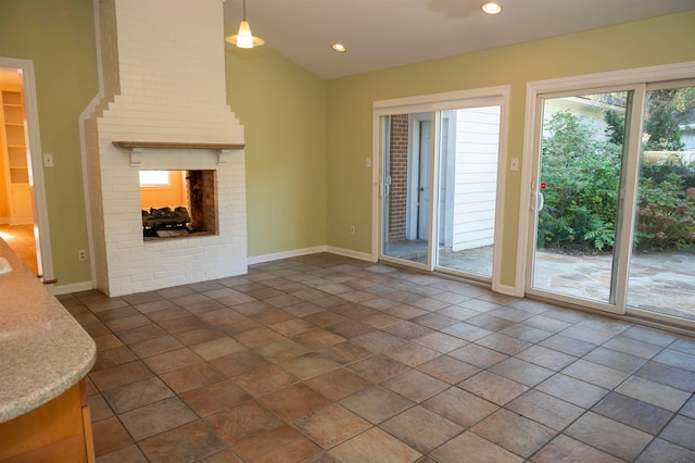 unfurnished living room featuring a brick fireplace