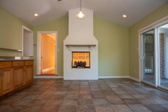 unfurnished living room featuring lofted ceiling and a brick fireplace