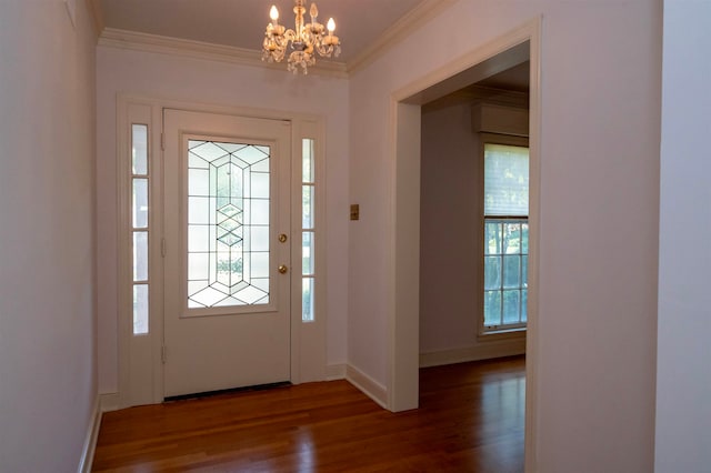 entryway with an inviting chandelier, dark hardwood / wood-style floors, and ornamental molding