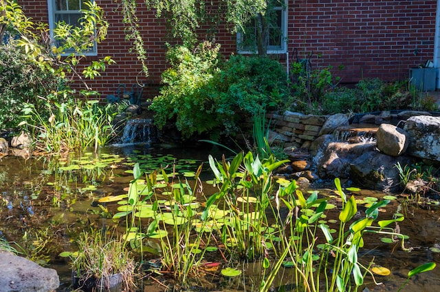 exterior details featuring a small pond