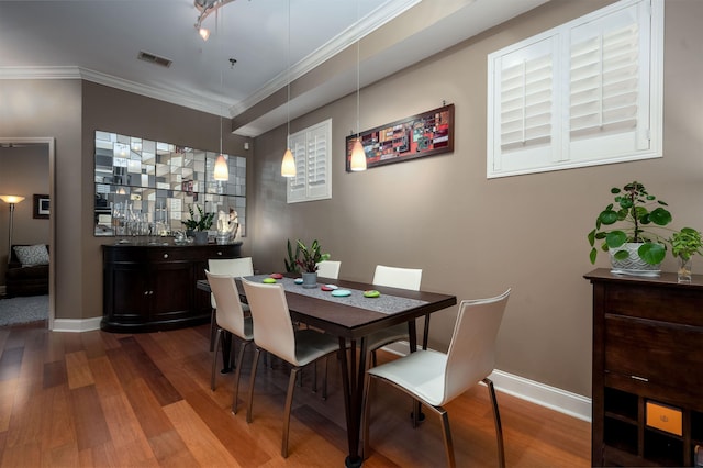 21 Mina Ave Unit 207, Memphis, TN 38103 - dining room featuring wood finished floors, baseboards, ornamental molding, and bar