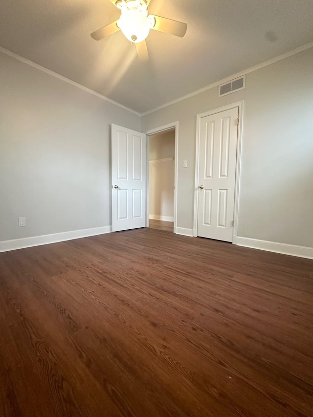 unfurnished bedroom with crown molding, ceiling fan, and dark hardwood / wood-style floors