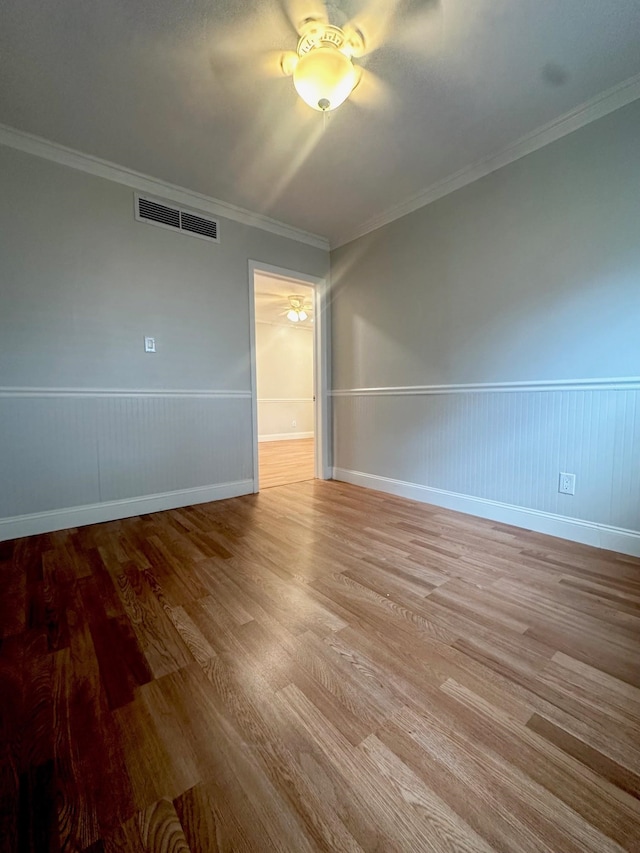 unfurnished room with crown molding, light hardwood / wood-style flooring, and ceiling fan