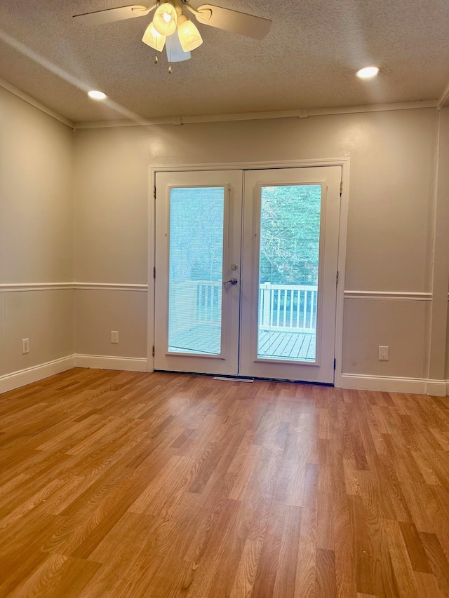 doorway to outside with french doors, ceiling fan, light hardwood / wood-style floors, and a textured ceiling