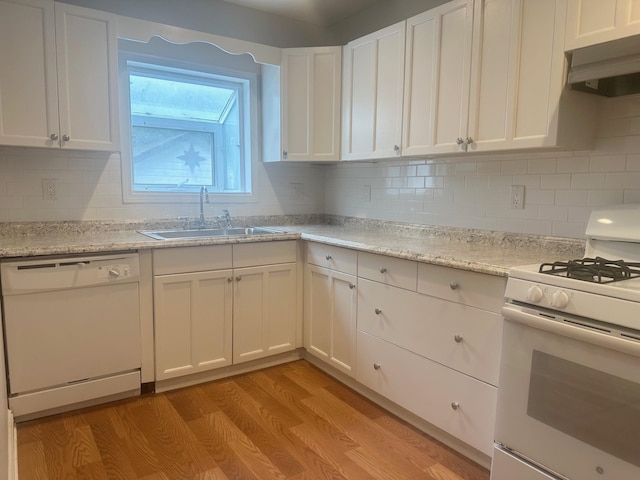 kitchen featuring range hood, white appliances, white cabinets, and sink