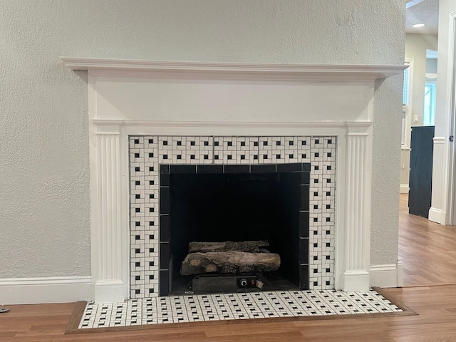 interior details featuring hardwood / wood-style flooring and a fireplace