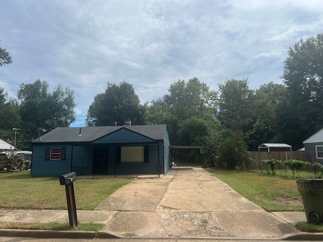 view of front of property with a front lawn and a carport