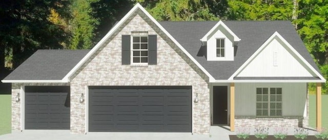 view of front of property featuring an attached garage, stone siding, and driveway