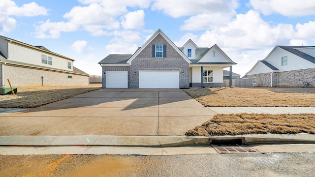 traditional-style home with a garage, driveway, and brick siding