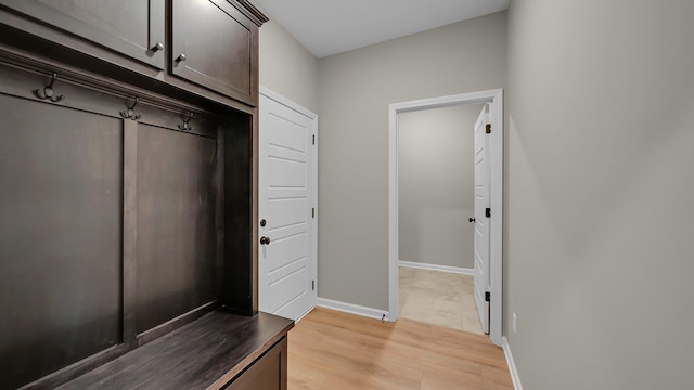 mudroom with light wood-style floors and baseboards