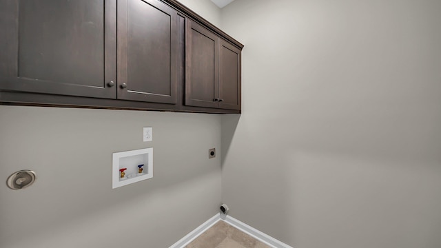 laundry area featuring baseboards, hookup for a washing machine, cabinet space, and hookup for an electric dryer