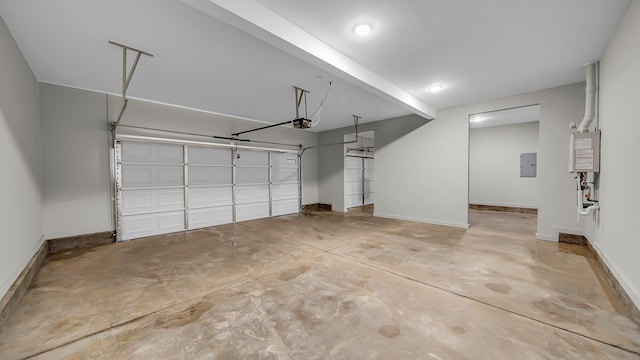 garage featuring electric panel, baseboards, and a garage door opener