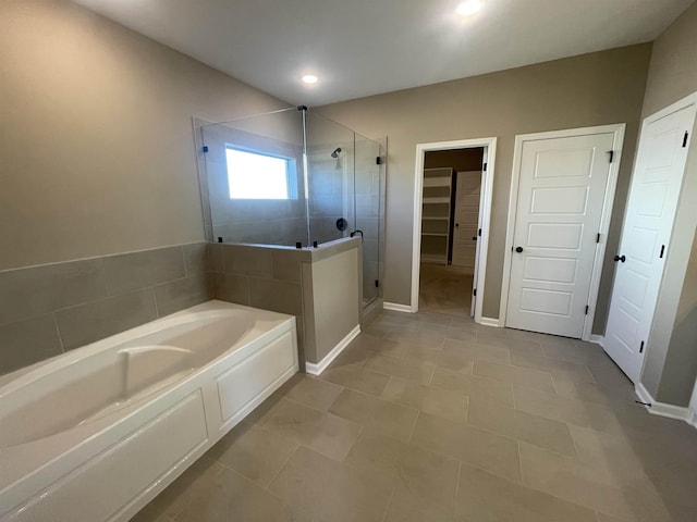 bathroom featuring separate shower and tub