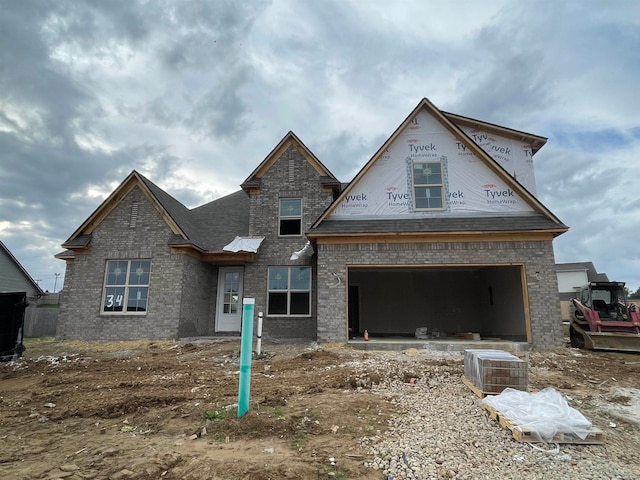 view of front facade with cooling unit and a garage