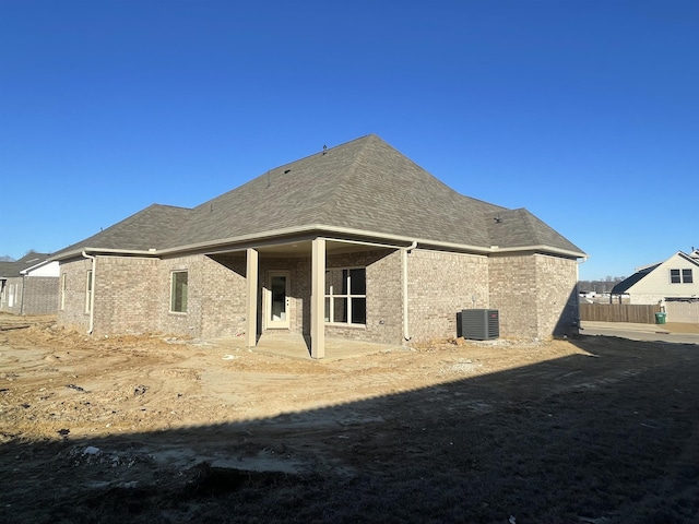 back of property featuring central AC