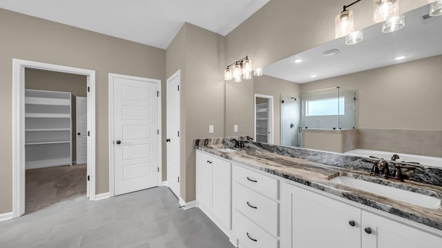 bathroom featuring vanity, tile patterned floors, and plus walk in shower