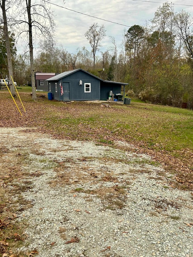 view of property exterior with an outdoor structure