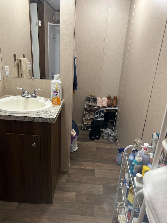 bathroom featuring hardwood / wood-style flooring and vanity