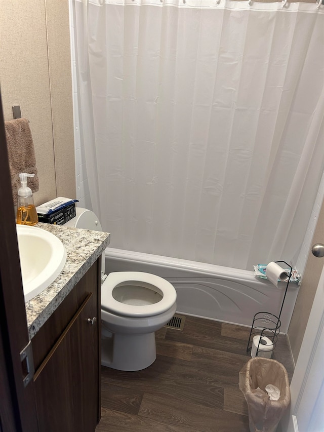 bathroom featuring vanity, wood-type flooring, and toilet