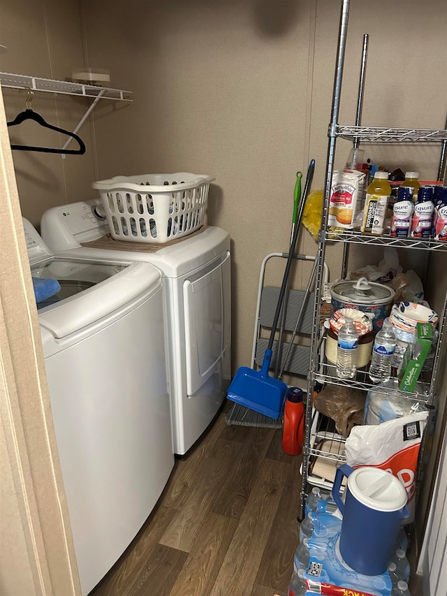 washroom with washing machine and clothes dryer and dark hardwood / wood-style flooring