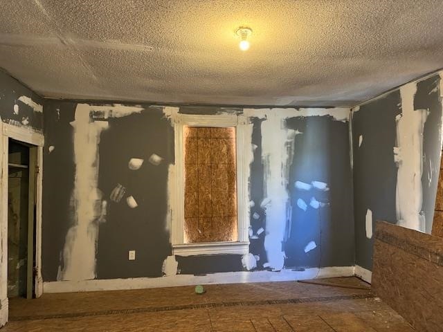 miscellaneous room with a textured ceiling