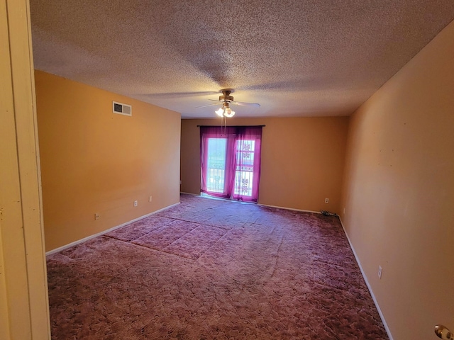 empty room with ceiling fan, carpet flooring, and a textured ceiling