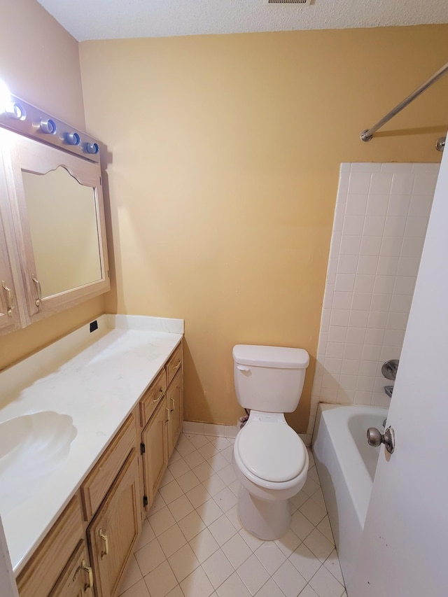 full bathroom with shower / bath combination, tile patterned floors, vanity, and toilet