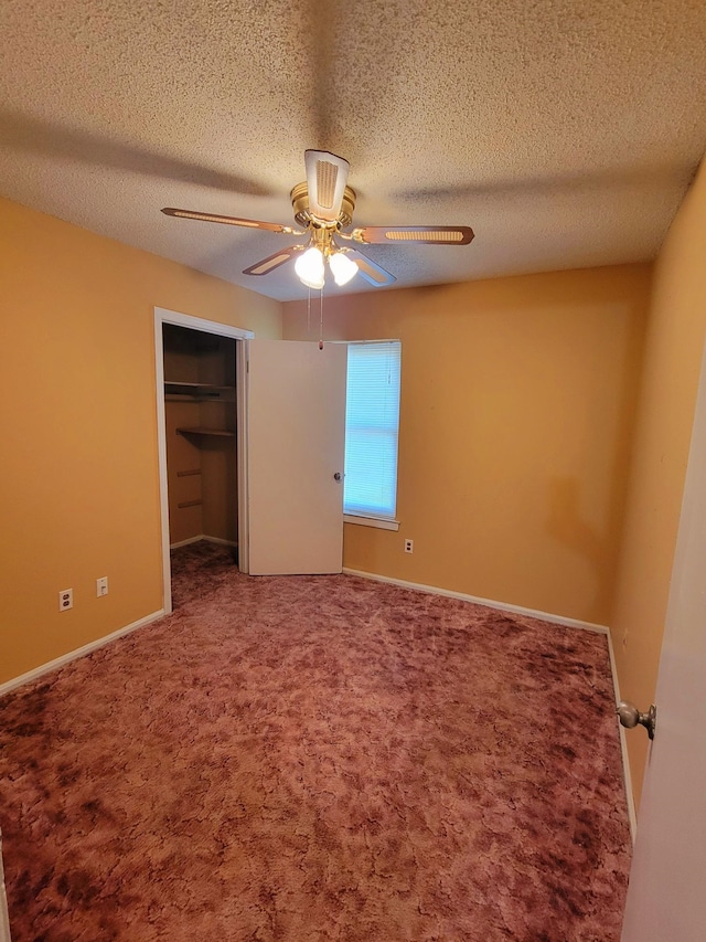 unfurnished bedroom with ceiling fan, a textured ceiling, a closet, and carpet flooring