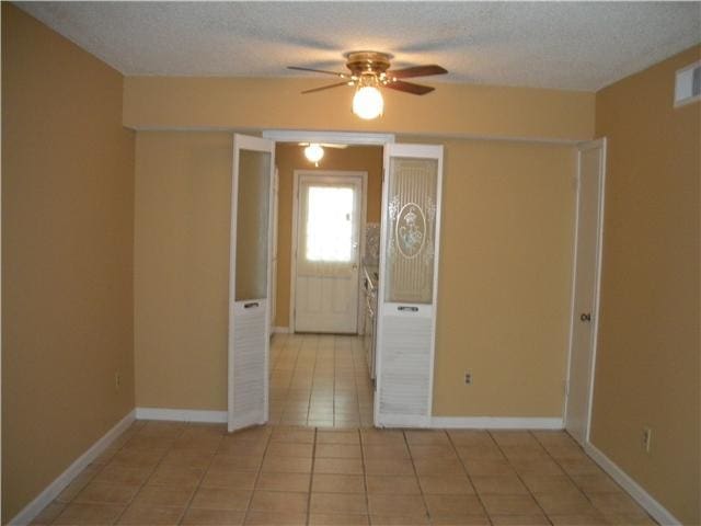 5273 Chatfield Dr Unit 5273, Memphis, TN 38116 - spare room with ceiling fan, light tile patterned flooring, a textured ceiling, and baseboards