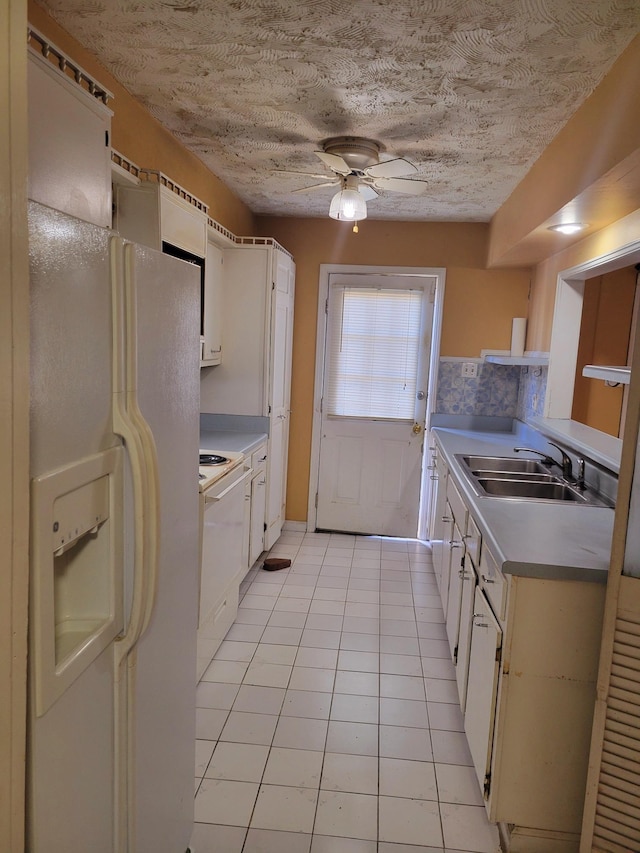 5273 Chatfield Dr Unit 5273, Memphis, TN 38116 - kitchen featuring white fridge with ice dispenser, a sink, stove, light tile patterned floors, and a ceiling fan