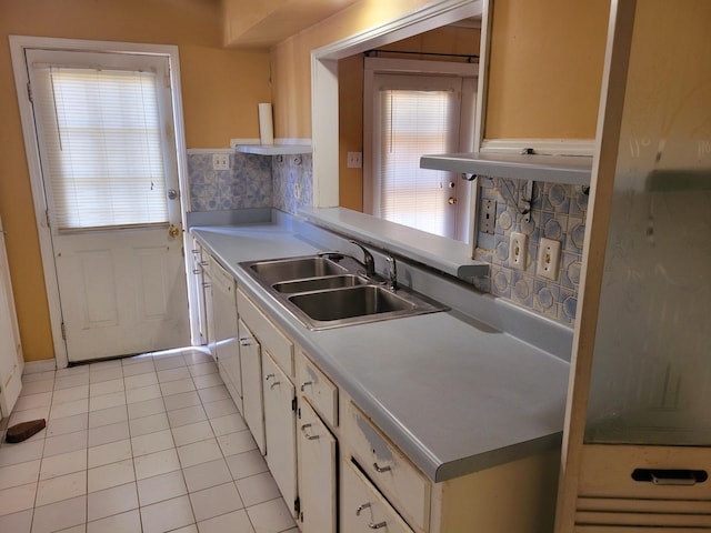 5273 Chatfield Dr Unit 5273, Memphis, TN 38116 - kitchen featuring a sink, light tile patterned flooring, light countertops, white cabinets, and tasteful backsplash