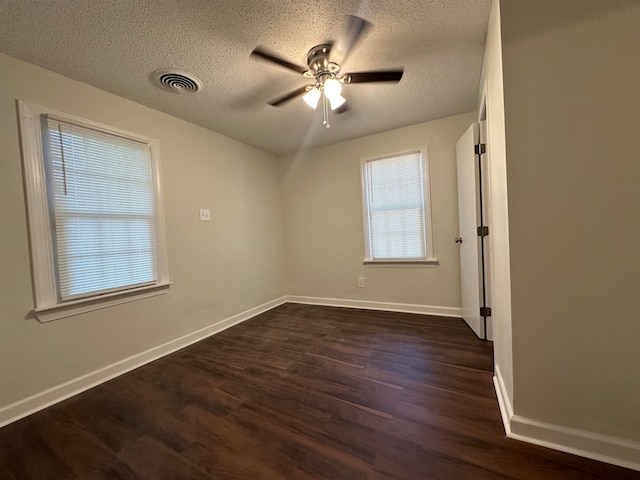 unfurnished room featuring a textured ceiling, ceiling fan, and dark hardwood / wood-style flooring