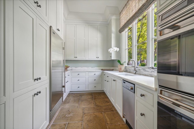 kitchen with white cabinets, appliances with stainless steel finishes, and sink