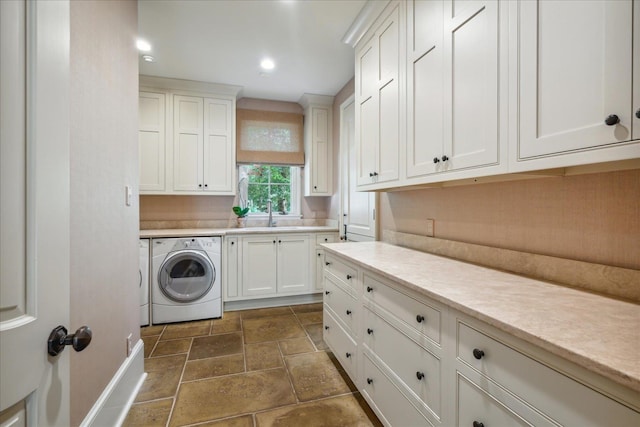 laundry area with washer and dryer and cabinets