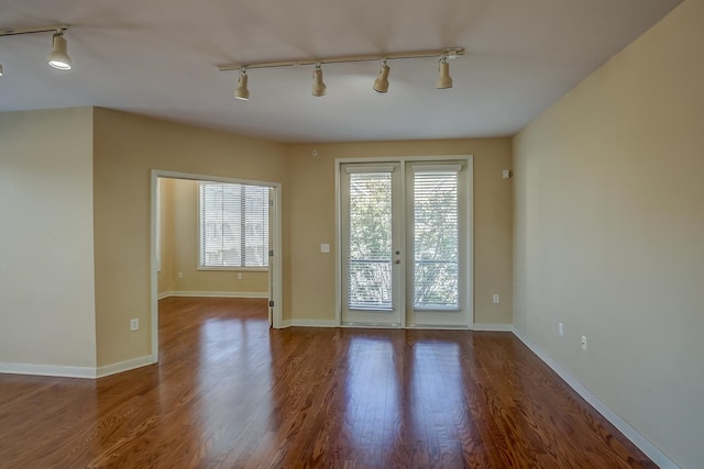 doorway to outside with hardwood / wood-style floors, track lighting, and french doors