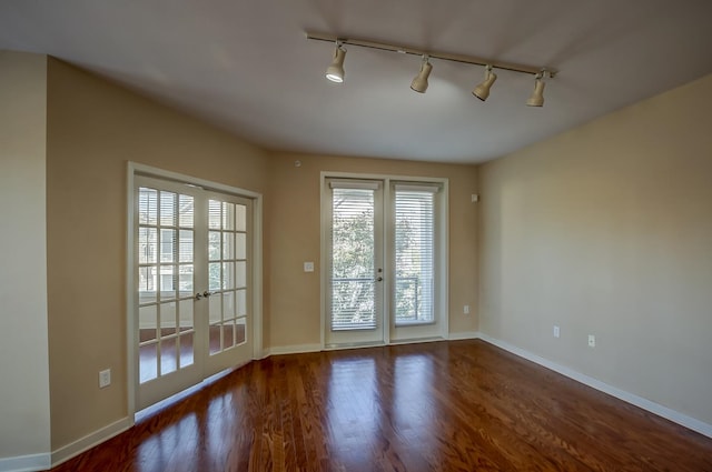 entryway with french doors, dark wood-type flooring, and track lighting