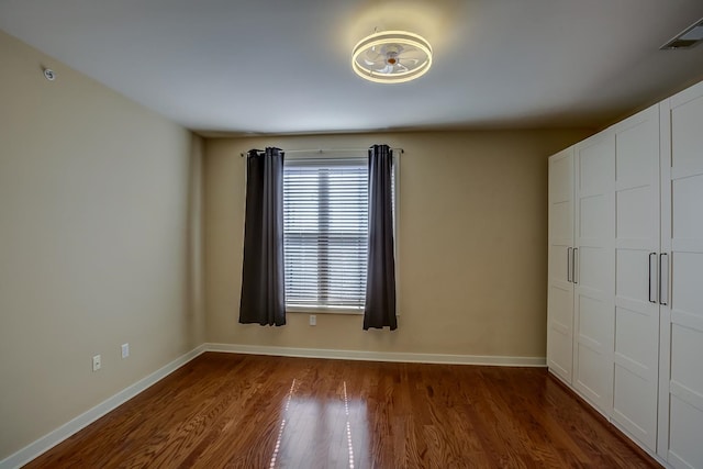 spare room with dark hardwood / wood-style floors