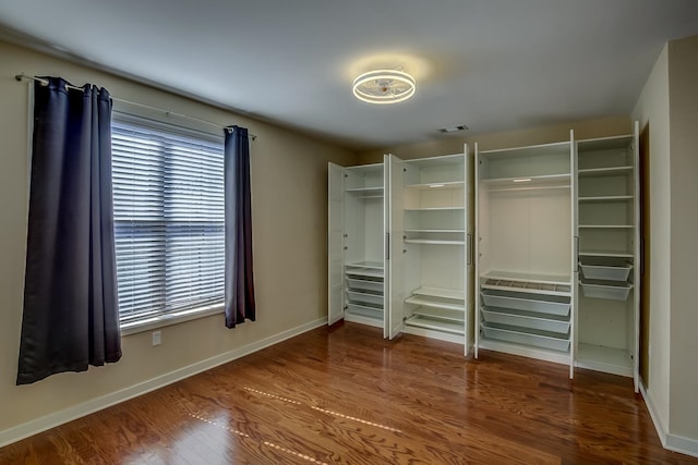 unfurnished bedroom with dark hardwood / wood-style flooring